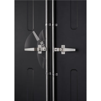 A close-up shows the latching mechanism of a dark-colored cabinet or door. Two vertical stainless steel bars run down the center where two horizontal handles with latching hardware meet and secure the doors.