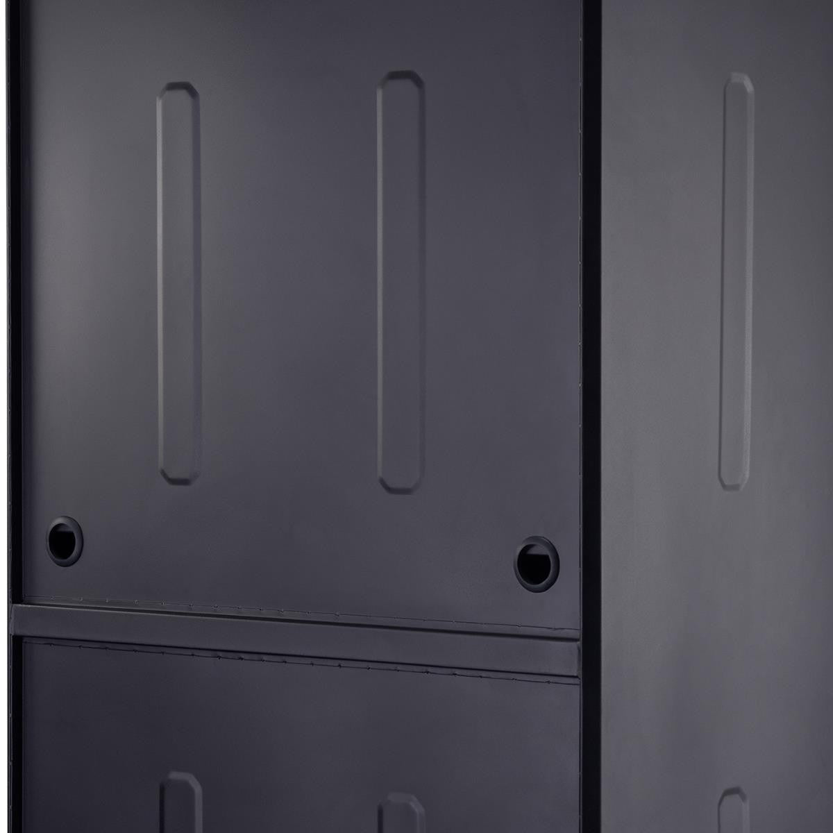 A close-up shows the textured, dark gray metal exterior of a garage cabinet system. The side of a cabinet with vertical recessed panels and circular holes is visible next to the front of another cabinet featuring similar design elements and a visible drawer line.