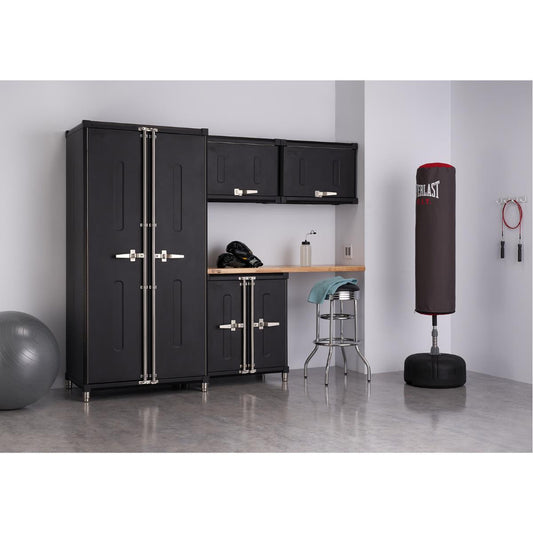A home gym or garage setup features a black Trinity PRO Series 5-piece garage cabinet with 1 locker cabinet, 1 base cabinet, 2 wall cabinet, and a 54 inch wide solid wood top set against a light gray wall. To the right, a black Everlast punching bag on a stand and a jump rope hang near a chrome stool with a light blue towel.