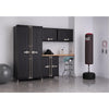 A home gym or garage setup features a black Trinity PRO Series 5-piece garage cabinet with 1 locker cabinet, 1 base cabinet, 2 wall cabinet, and a 54 inch wide solid wood top set against a light gray wall. To the right, a black Everlast punching bag on a stand and a jump rope hang near a chrome stool with a light blue towel.