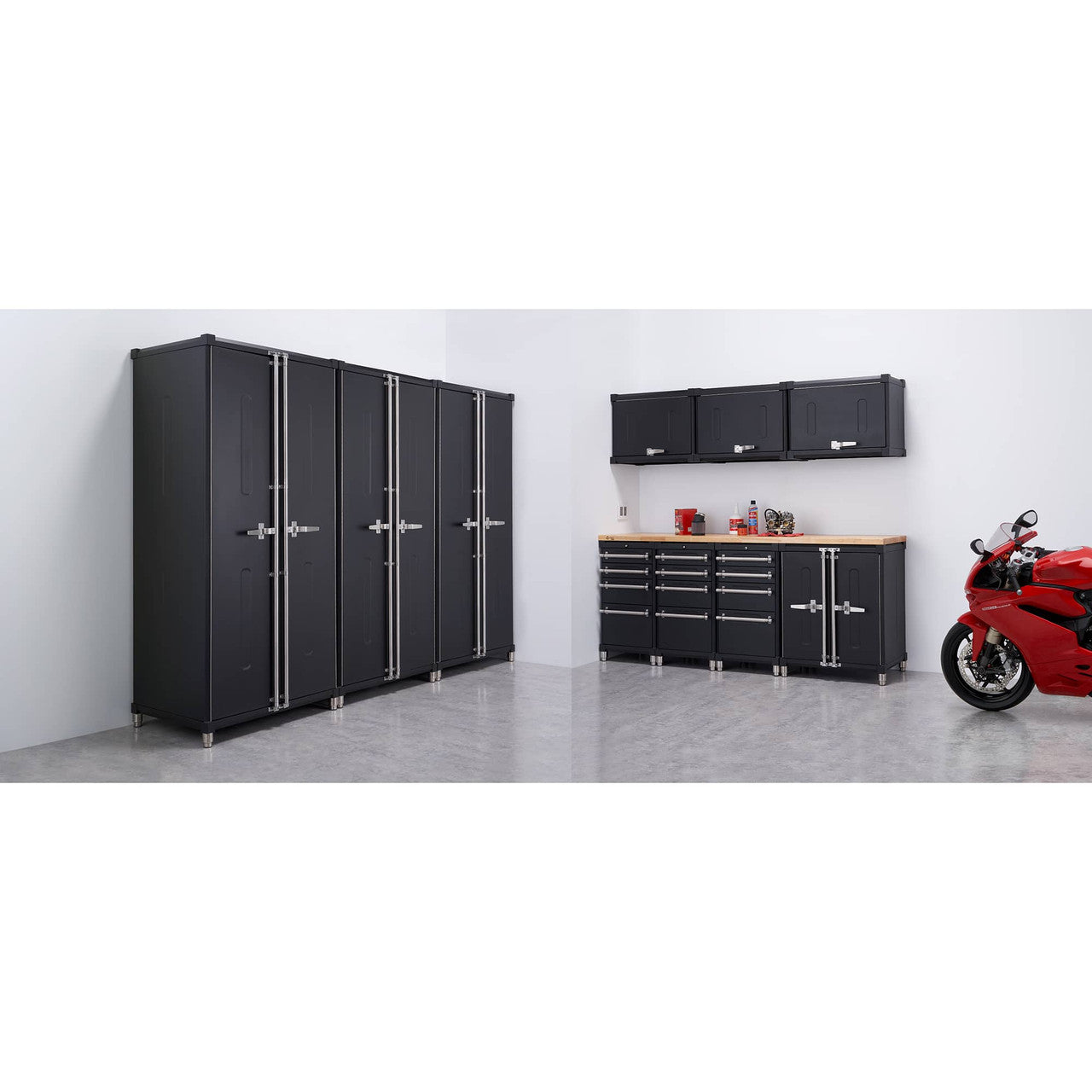 A well-organized garage features a black Trinity PRO 11-piece garage cabinet drawer set along the left and back walls, providing ample storage. A red motorcycle is parked on the right side of the polished concrete floor.