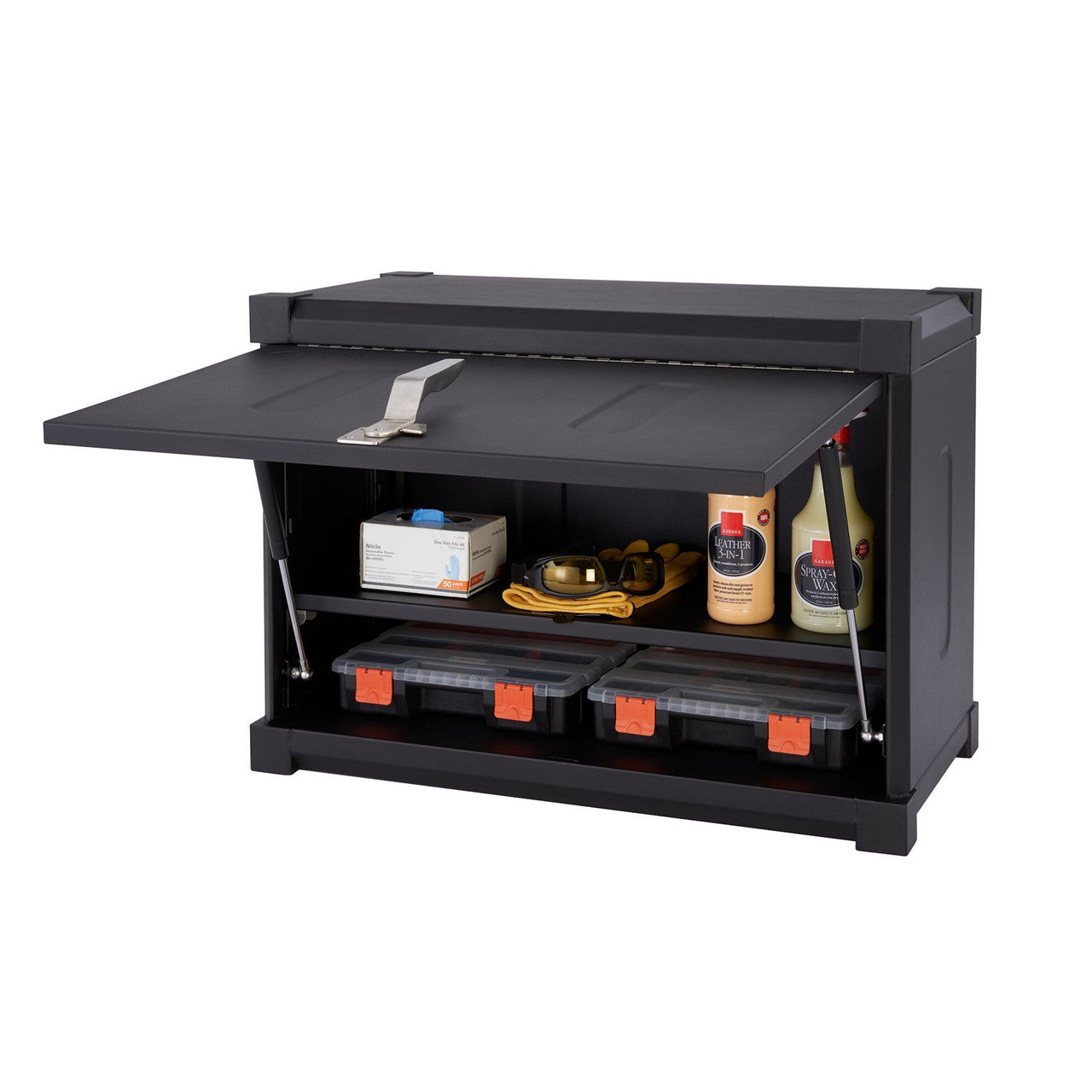 A black metal wall-mounted garage cabinet is shown open, revealing two shelves. The top shelf holds a box of gloves, safety glasses on a yellow cloth, and two bottles of automotive liquids. The bottom shelf contains two black plastic storage containers with orange latches.