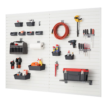 A well-organized garage wall system features two white slatwall panels with various tools and supplies neatly arranged. Baskets, hooks, and shelves hold items like power drills, screwdrivers, a garden hose, a toolbox, and cleaning supplies.