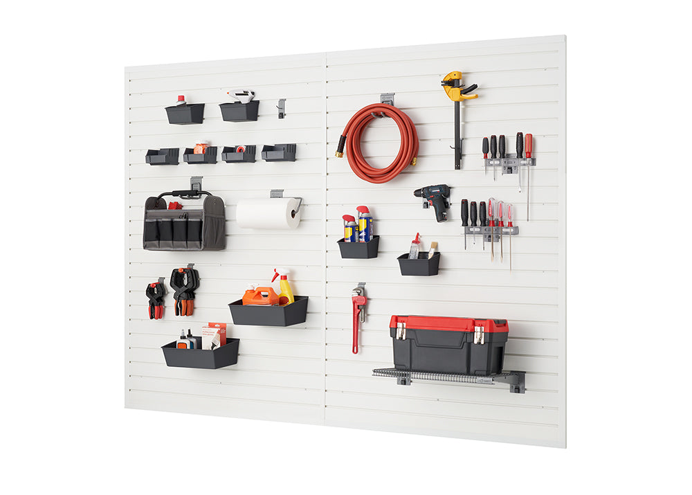 A well-organized garage wall system features two white slatwall panels with various tools and supplies neatly arranged. Baskets, hooks, and shelves hold items like power drills, screwdrivers, a garden hose, a toolbox, and cleaning supplies.