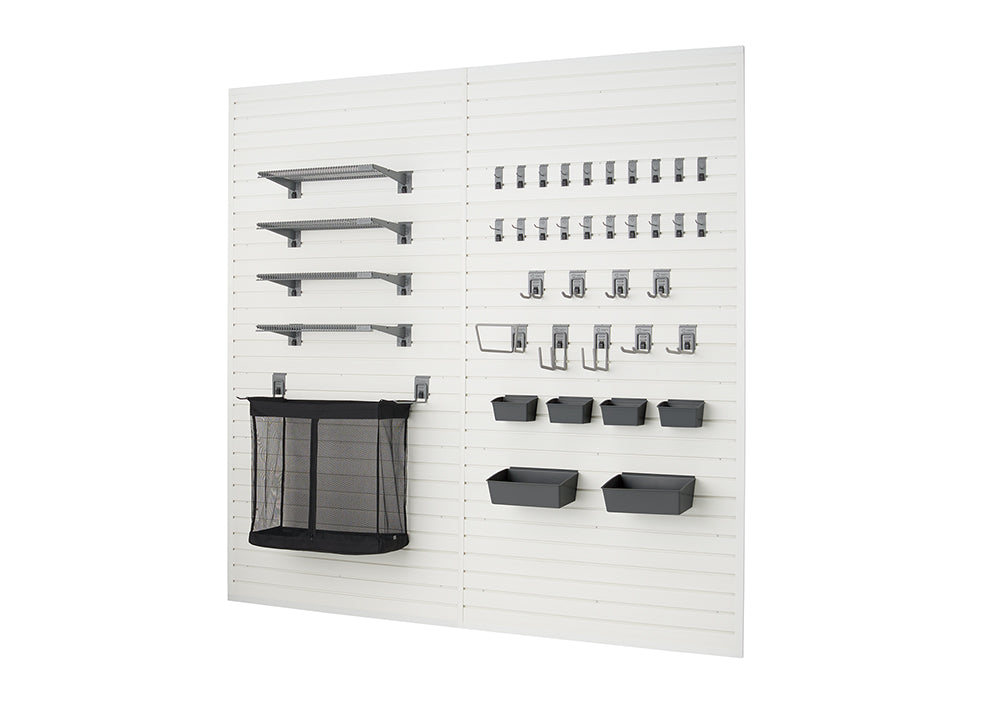 A modular garage organization system is shown, featuring white slatwall panels with various dark gray accessories. On the left are four shelves of different lengths and a large mesh storage bin, while the right side displays multiple rows of hooks and several small bins.