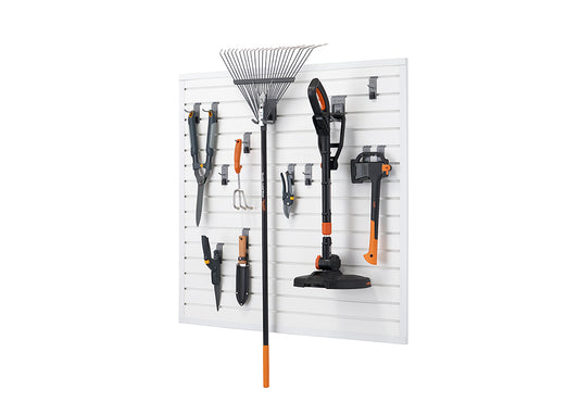 A white modular slatwall system measuring 16 square feet is mounted on a white background, displaying various gardening tools. The tools, including a leaf rake, hedge trimmer, axe, shears, and small hand tools, are neatly organized using different types of hooks and brackets attached to the horizontal slats.
