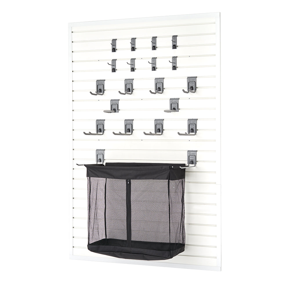 A white slatwall storage panel is equipped with multiple gray hooks, brackets, and a large black mesh storage bin with a zippered front. The modular design allows for customizable organization, ideal for garages or utility rooms.