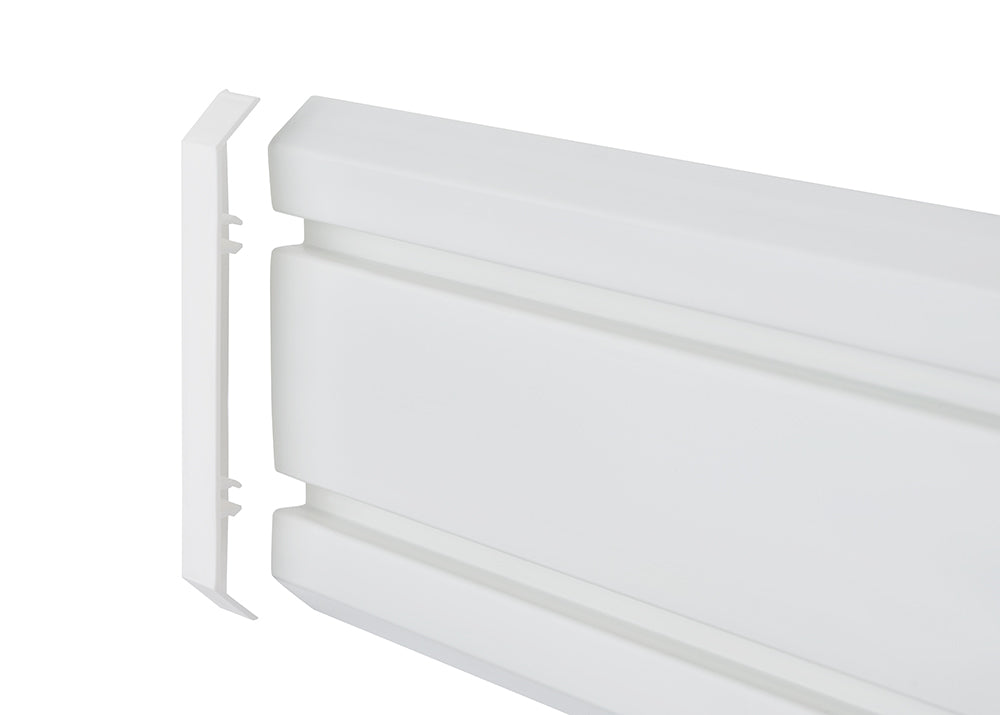 A white, plastic baseboard heater cover is shown. A detached end cap is visible to the left, revealing the internal structure of the main cover piece.