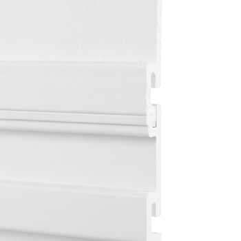 A close-up image of a white interlocking wall panel with a grooved design. The panel appears to be made of PVC or a similar material, showcasing its tongue-and-groove connection system.