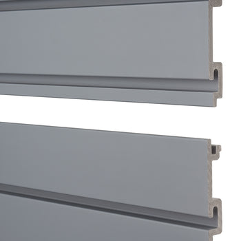 Two horizontal, grey slatwall panels are stacked against a white background. The top panel is slightly above the bottom panel, revealing their interlocking design and the raw, unpainted edges of the material on the right side.