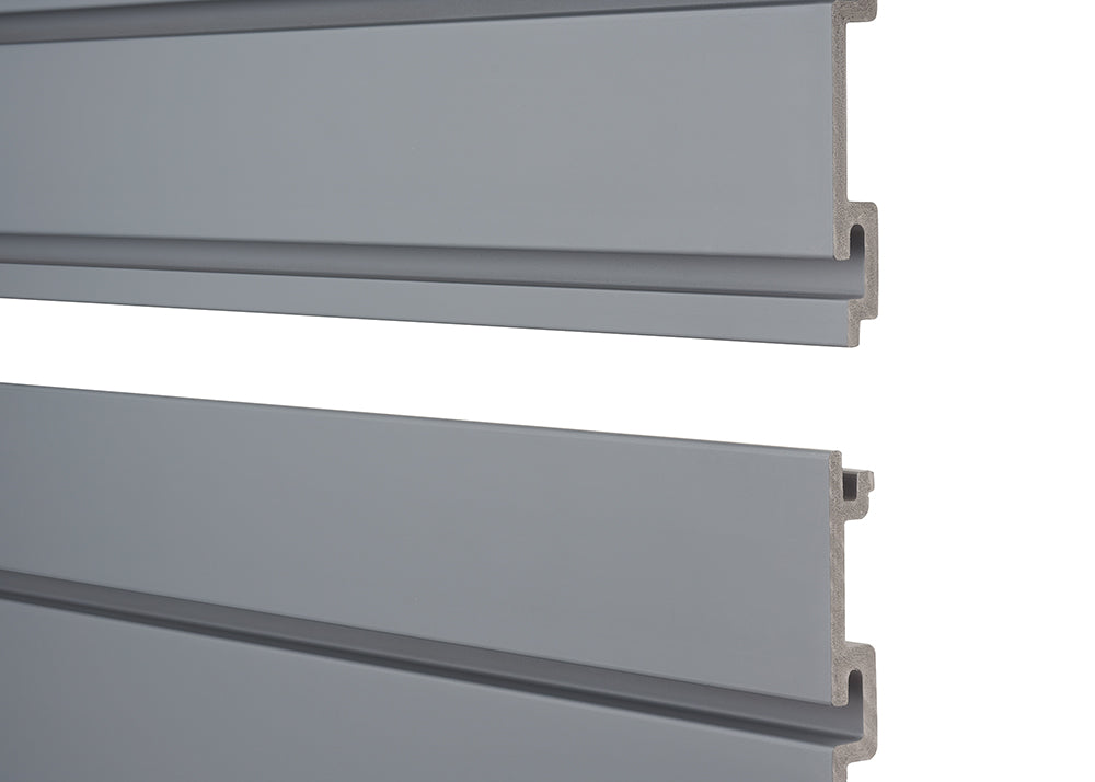Two horizontal, grey slatwall panels are stacked against a white background. The top panel is slightly above the bottom panel, revealing their interlocking design and the raw, unpainted edges of the material on the right side.