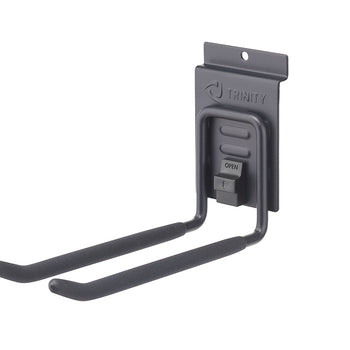 A close-up shot shows a black Trinity garage hook designed for hanging tools or equipment. The hook features two padded arms extending from a wall-mounted bracket with the Trinity logo and an 