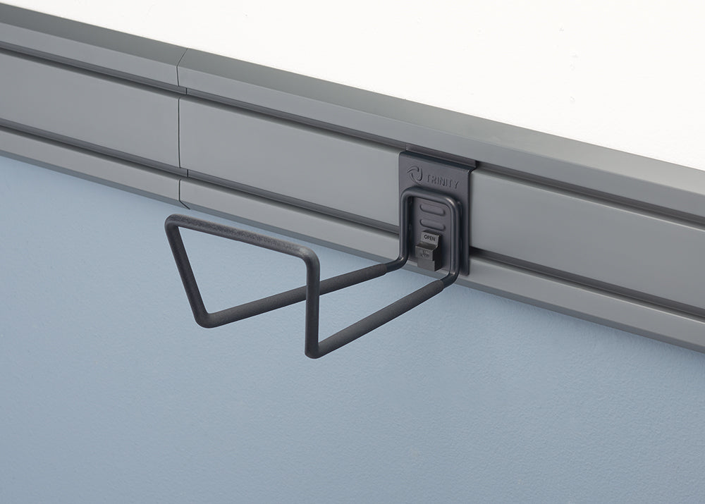 A gray, wall-mounted steel utility hook is attached to a rail system. The hook has a black matte finish and is designed to hold items with a "U" shaped cradle.