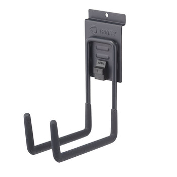 
A close-up of a black Trinity brand wall-mounted J-hook. The hook has two prongs with soft, black foam grips and a locking mechanism with a small lever that says 