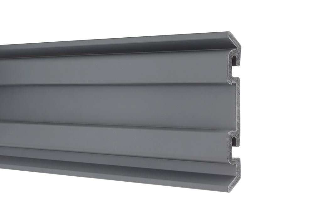 A horizontal close-up shot of a gray slatwall panel with a cut-out profile revealing its hollow interior. The panel features two long, horizontal grooves running along its length.