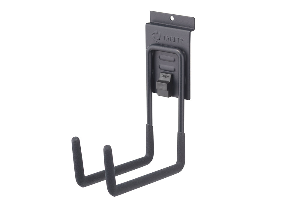 A gray Trinity J-hook hangs on a wall mount, with a locking mechanism that reads "OPEN." The J-hook has two rubberized prongs for holding items.