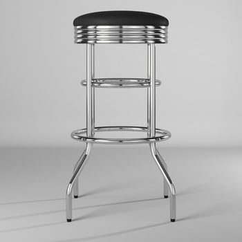 A retro-style chrome bar stool is positioned centrally against a plain gray background. The stool features a black, padded swivel seat with horizontal chrome banding, supported by a polished chrome frame with two circular footrests and four flared legs.
