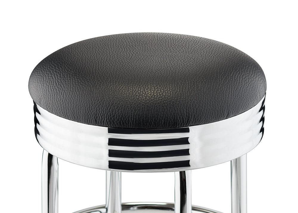 A close-up of a black and chrome bar stool with a retro design. The stool has a round, black, textured seat and a shiny chrome base with three horizontal black stripes.