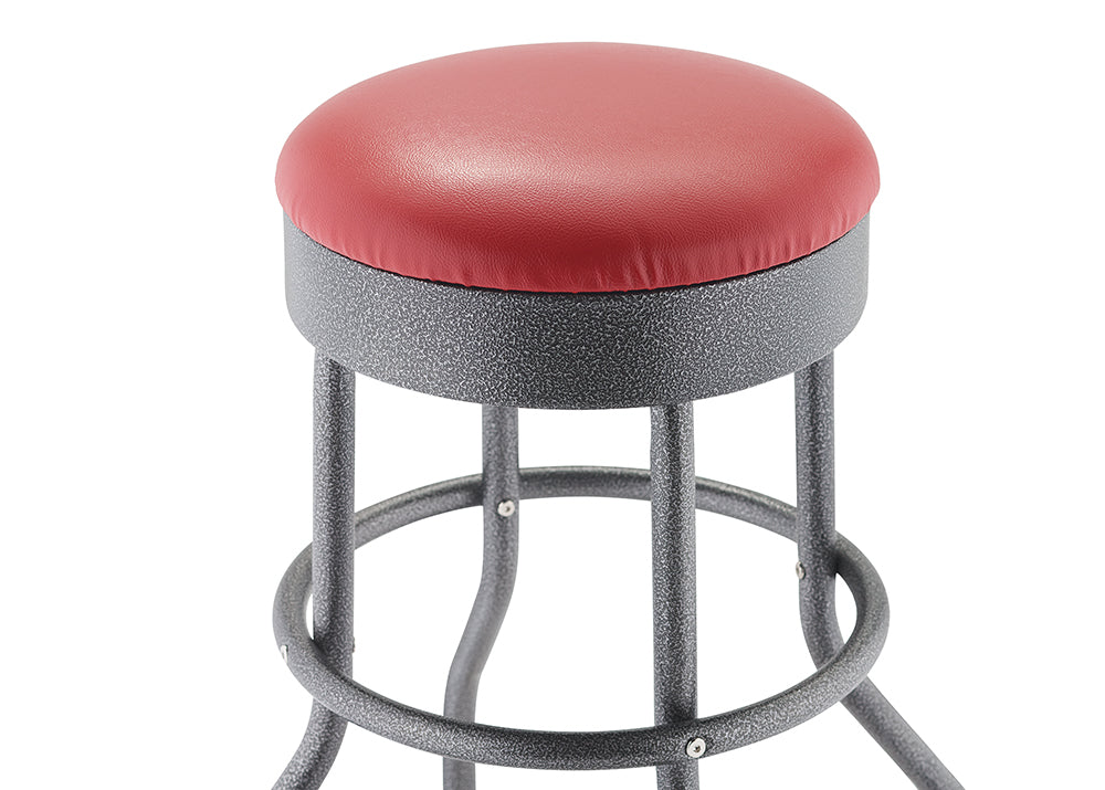 A close-up of a bar stool featuring a red, round, upholstered seat. The stool has a textured, speckled black metal frame with a circular footrest.