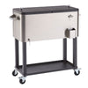 A stainless steel  100 quart cooler with a split black lid sits on a dark gray metal stand with black rubber wheels. The cooler has handles on the sides, a bottle opener, and a bottle cap catcher.
