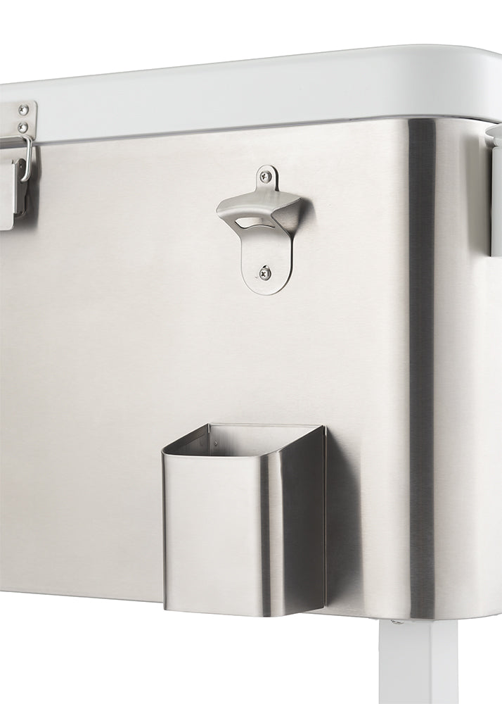 A close-up shot of a stainless steel cooler shows a built-in bottle opener and a small, rectangular storage bin attached to its side. The cooler has a shiny, brushed metal finish and a white lid that is partially visible at the top.