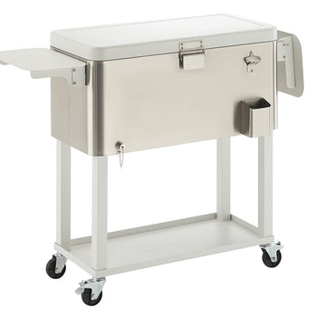 A sleek, silver outdoor cooler on a white rolling cart is presented against a white background. The cooler features a bottle opener, an attached side shelf, and a lower storage shelf on the cart.