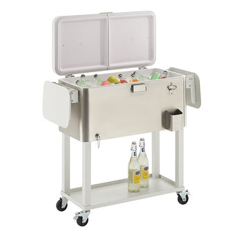 A large, rectangular stainless steel cooler with a white frame and wheels is shown, with its hinged lid open to reveal various bottled drinks on ice. The cooler features side tables, a bottle opener, and a lower shelf where two additional bottles rest.
