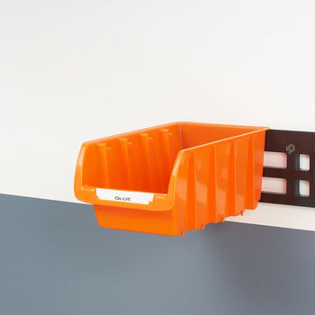 An orange bin mounted on the wall using wall mount rails.