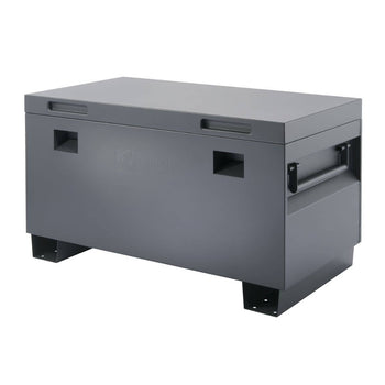A gray, rectangular Trinity job site box with a hinged lid sits on a white background. The box has handles on the sides and the word 