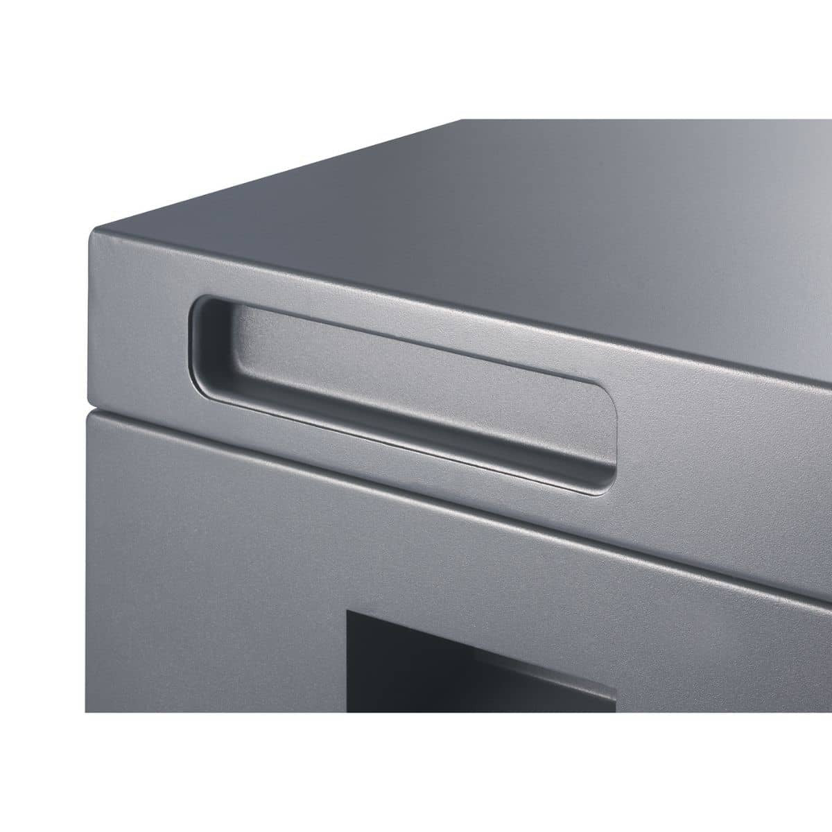 A close-up shot shows the top corner of a metallic gray storage box, featuring a recessed rectangular handle on its side. The texture of the metal appears slightly rough or matte.