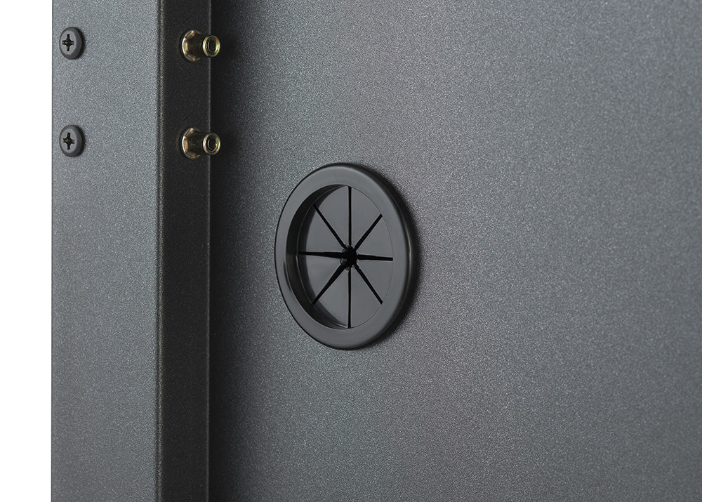 A close-up view highlights a circular rubber cable management grommet built into the back panel of a dark gray steel storage cabinet. The flexible rubber pass-through port allows power cords to pass through cleanly while keeping interior wiring neat and organized.