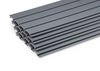 A stack of several 4 ft. by 1 ft., flat, rectangular grey panels, likely made of plastic or composite material, is shown against a plain white background. The panels appear to interlock, suggesting they are designed for cladding, decking, or a similar construction purpose.