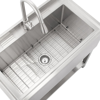 An elevated, high-angle view captures a modern stainless steel freestanding utility sink and faucet set on a white background. It features a deep sink basin with a bottom grid and drain assembly, a pull-down faucet with a single handle, and a bottom shelf.