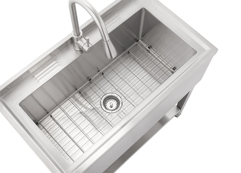 An elevated, high-angle view captures a modern stainless steel freestanding utility sink and faucet set on a white background. It features a deep sink basin with a bottom grid and drain assembly, a pull-down faucet with a single handle, and a bottom shelf.