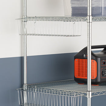 Metal wire shelving unit with two wire baskets attached beneath the shelves. The unit holds a clear storage bin with folded towels and a black and orange portable power station.