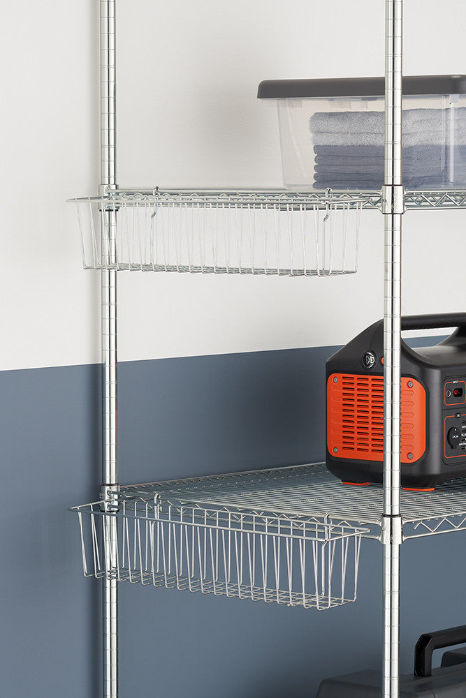 Metal wire shelving unit with two wire baskets attached beneath the shelves. The unit holds a clear storage bin with folded towels and a black and orange portable power station.